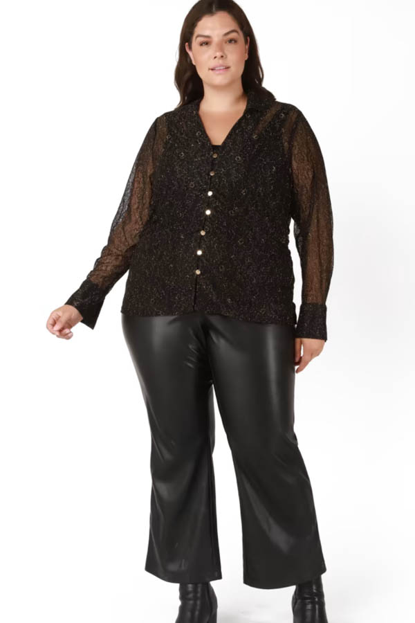 Model wears black blouse with sheer sleeves from plus-size clothing store Dia and co.