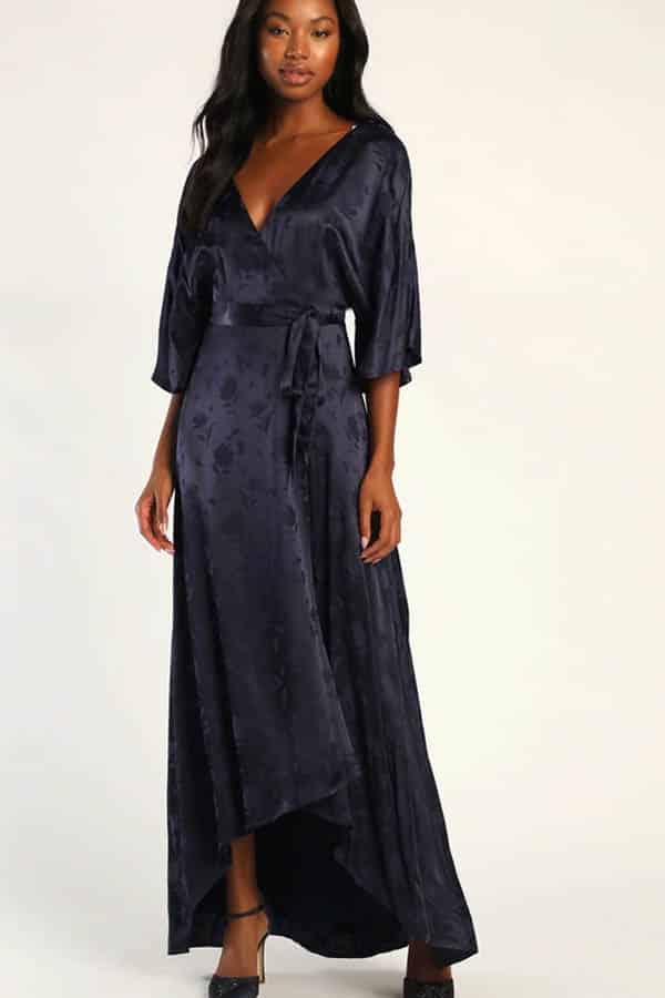 Model wears navy blue, floor-length party dress.