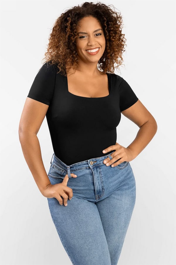 Woman wearing bodysuit with jeans.