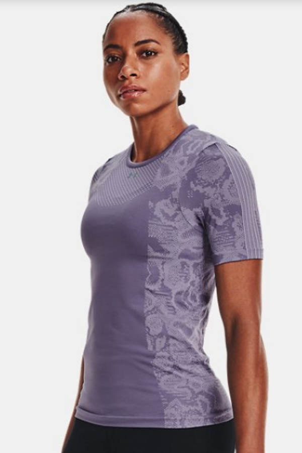 Model wears lavender workout top from Under Armour.