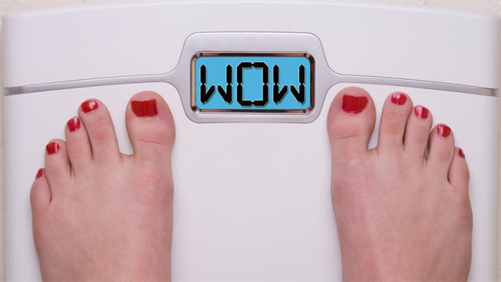 Close up view of women's feet on scale, to represent the best clothes for weight loss.