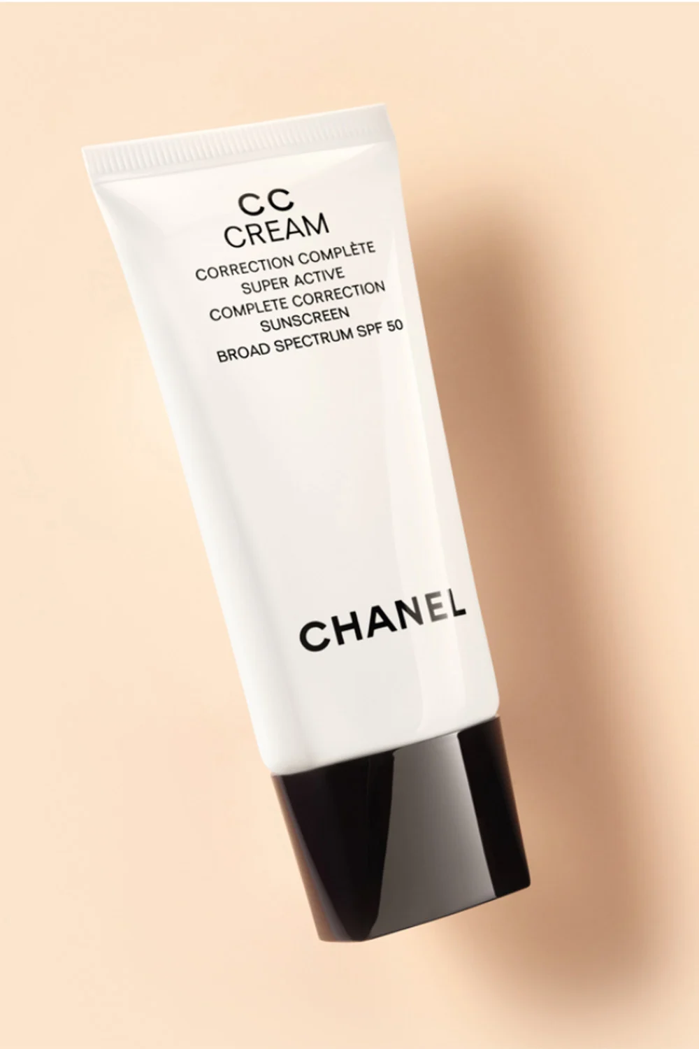 Chanel CC cream on beige background. 