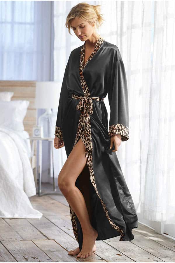 Model wears long black robe with cheetah print details.