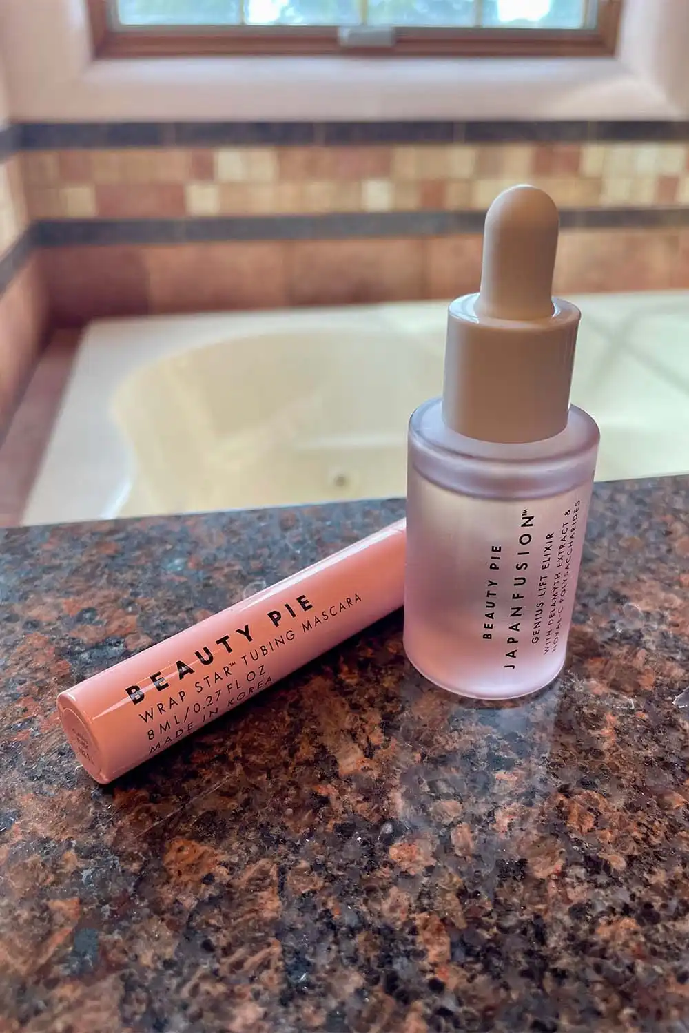 Close up view of Beauty Pie beauty serum and mascara.