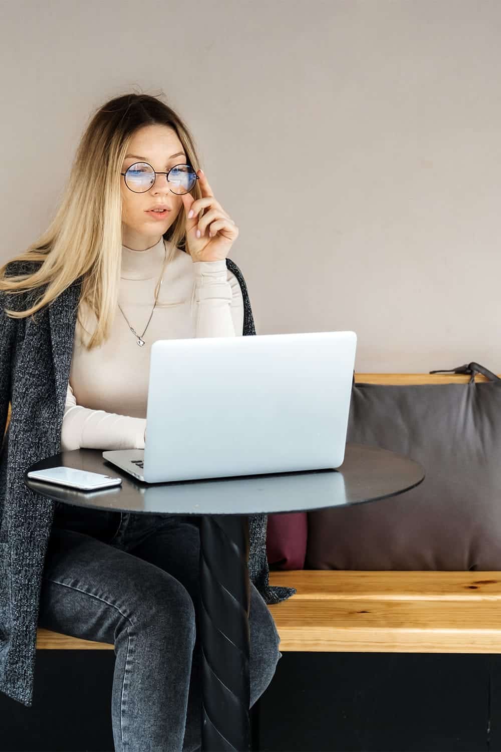 Woman works her side hustle from a coffee shop.