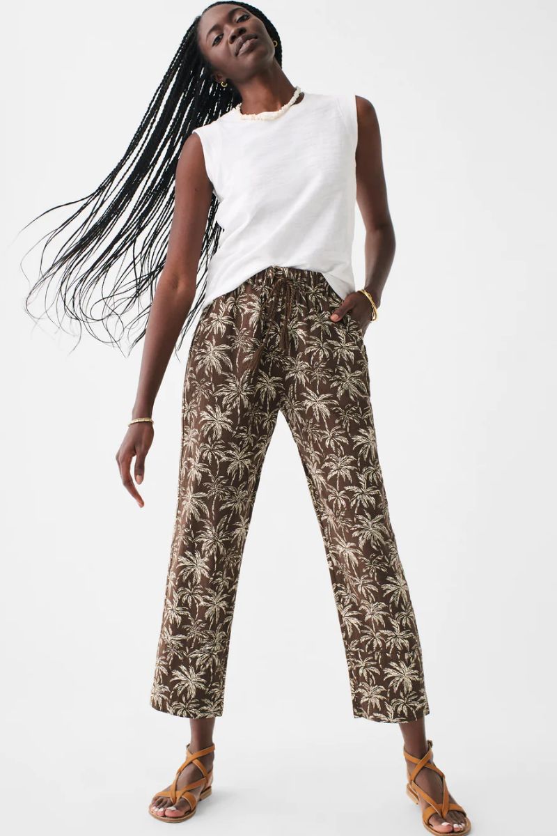 Model wearing tropical print, ankle-length pants.