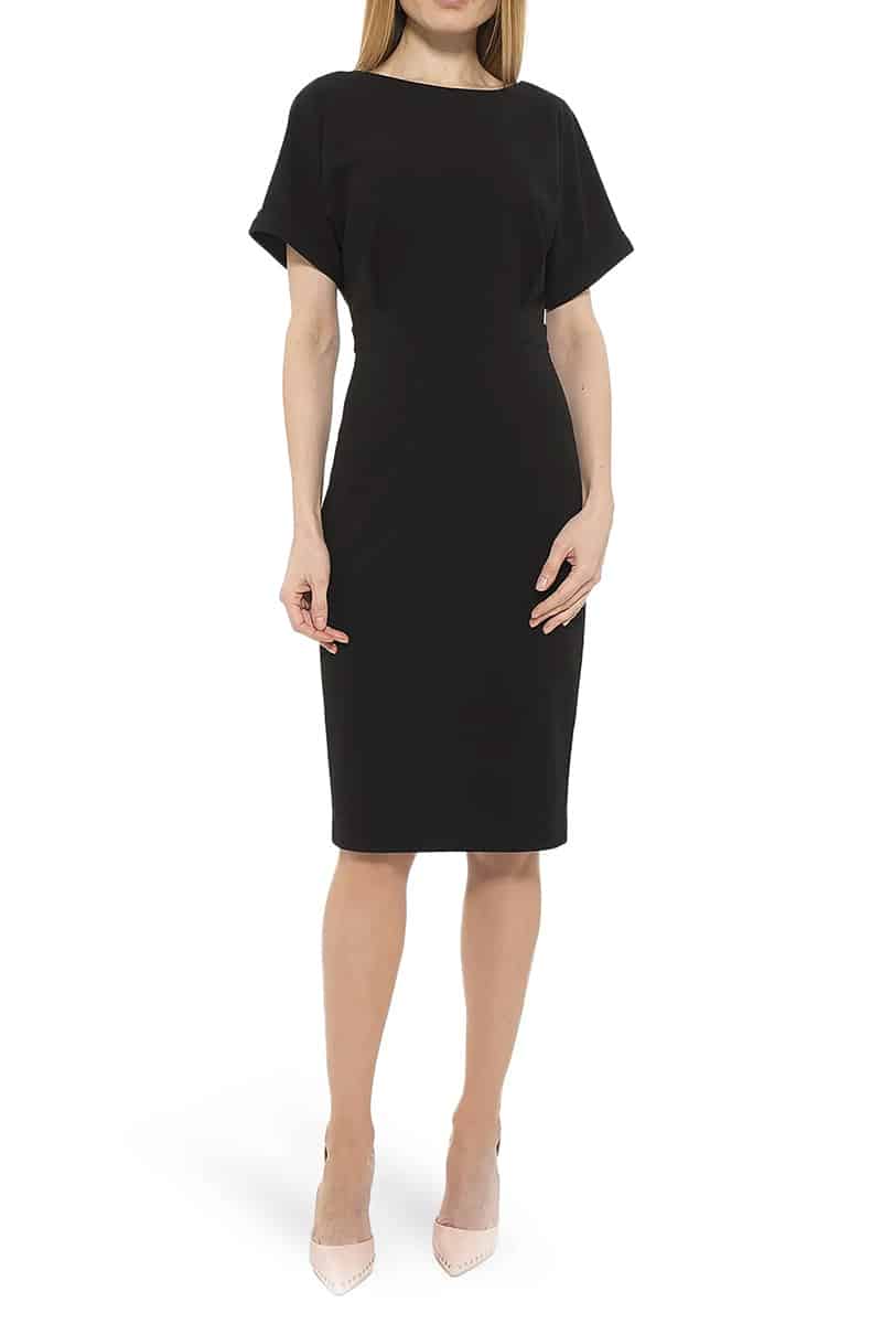 Model wears black dress with dolman sleeves, ideal outfit for a high school reunion. 