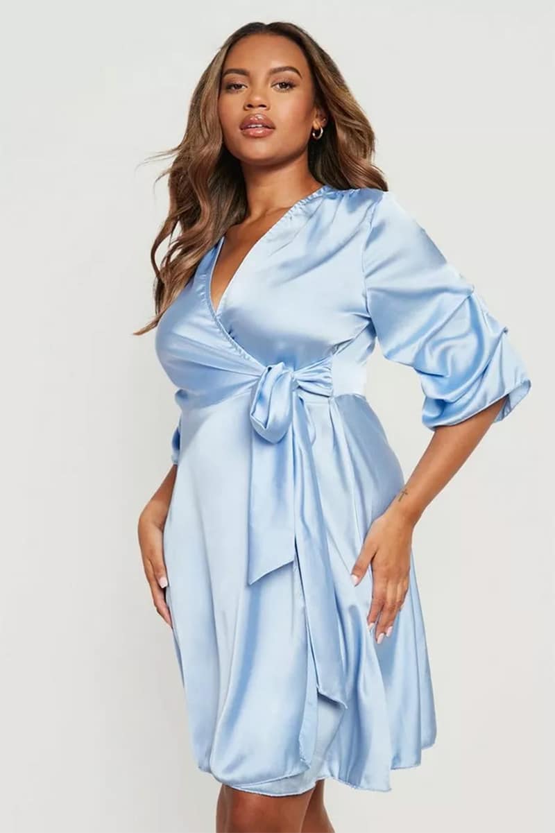 Model wears wrap satin dress. 
