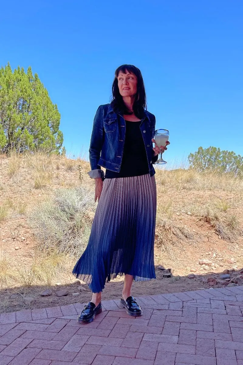 Catherine Brock wearing chunky loafers with pleated maxi skirt.