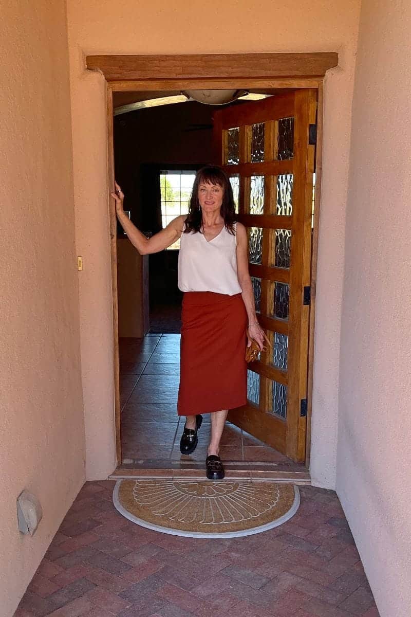 Catherine Brock wearing midi skirt, loose tank top, and chunky loafers.