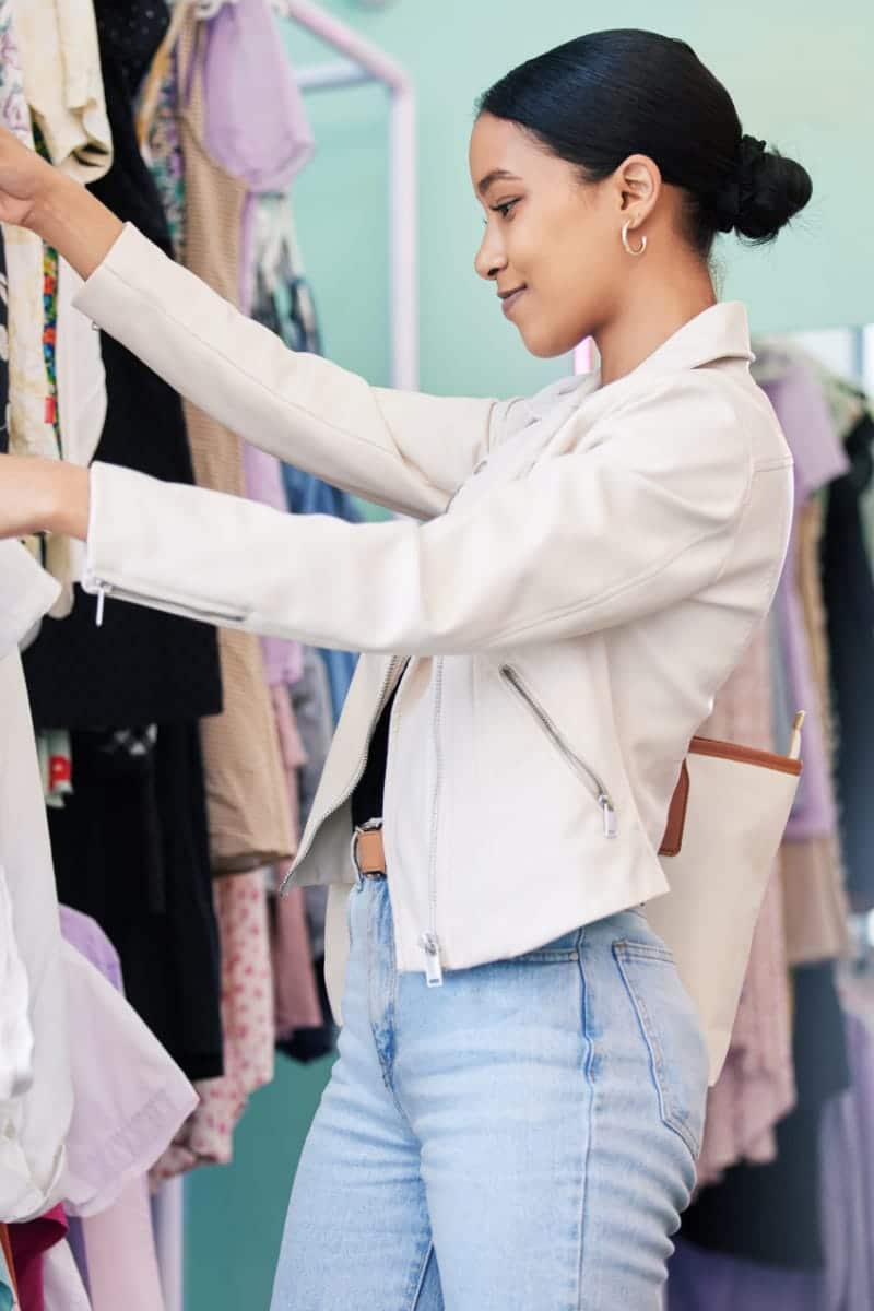 Loyal shopper shops in department store to represent Macy's Star Rewards.