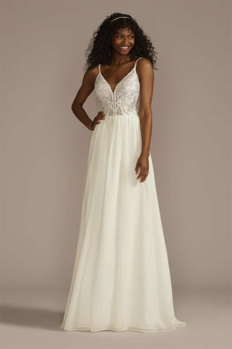 The Pam Beesly Wedding Dress from David's Bridal 2 Model wears white wedding gown with spaghetti straps.