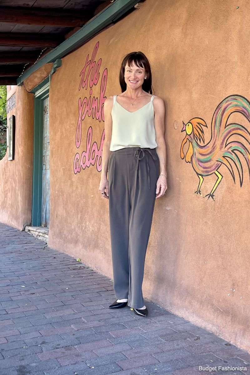 Catherine Brock wearing green cami and gray trousers for Chicwish reviews. 