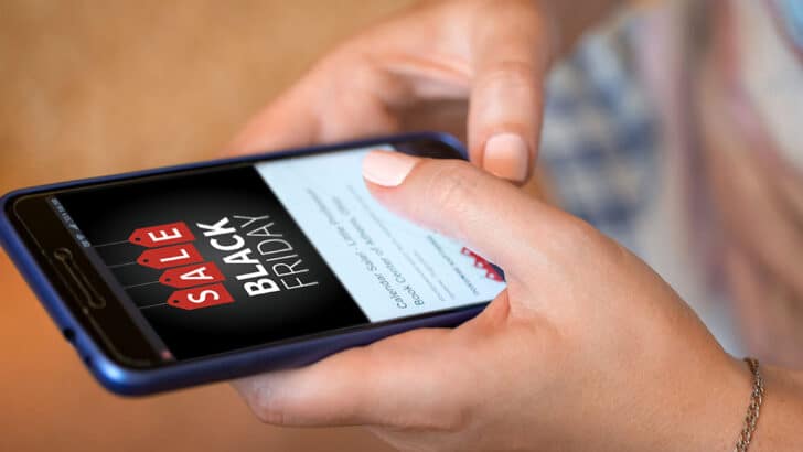 Woman uses phone to search for Amazon Black Friday deals.