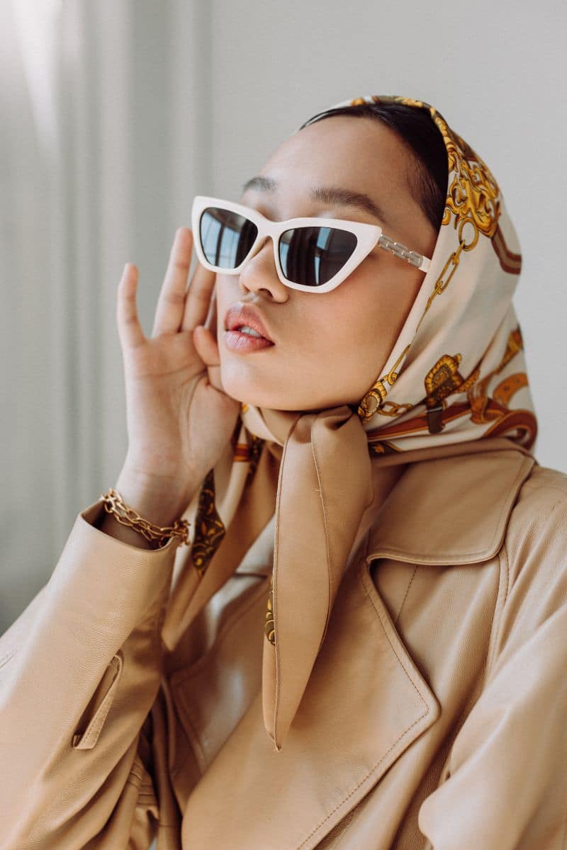 Look Rich on a Budget: 9 Pieces to Shop Now 2 Woman wearing silk scarf as headwrap and sunglasses.