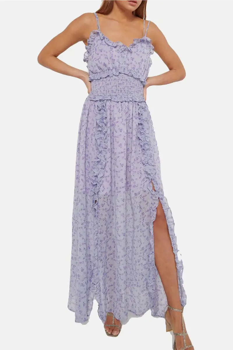 Model wears purple dress with ruffles.