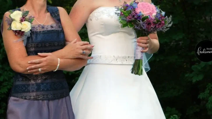Shoulder to hip view of two women in formal dresses walking side by side.