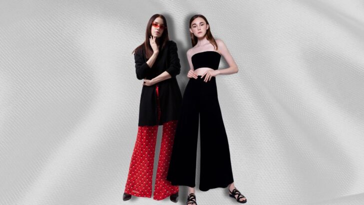 Two women wearing wide-legged pants against a textured background.