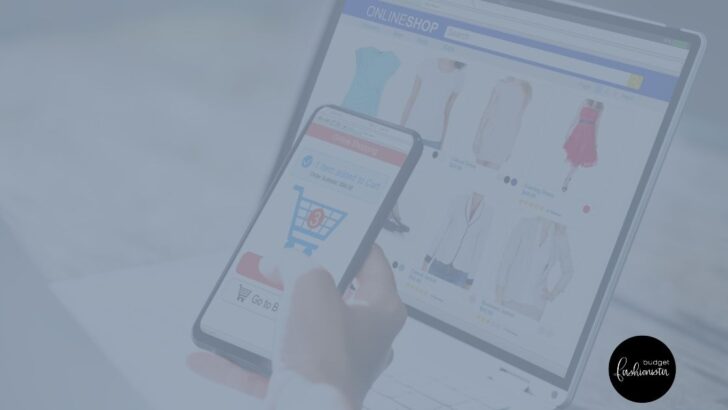 Handing holding mobile phone with shopping site on screen.