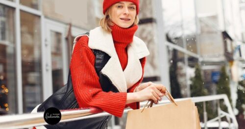 Woman wearing turtleneck sweater with vest and beanie.