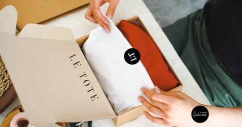 Top view of woman opening up a Le Tote branded box.