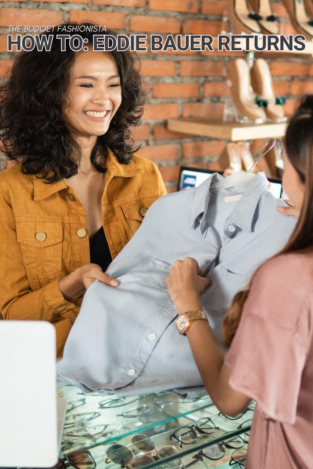 Two women smiling while holding shirt with text overlay