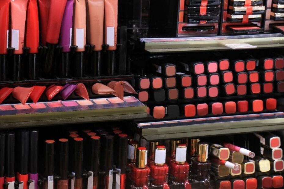 Cosmetic store display with rows of lipstick and nail polish