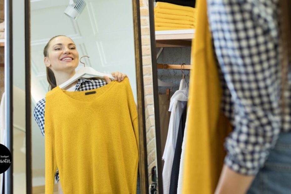 Woman tries on clothes at home in front of mirror