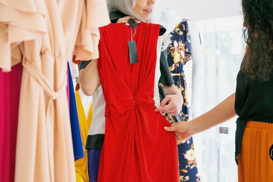 Woman adjusting red dress in fitting room