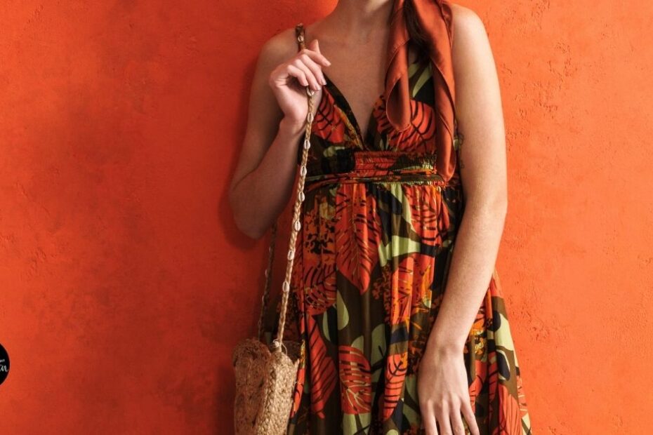 Woman in floral summer dress holding woven bag