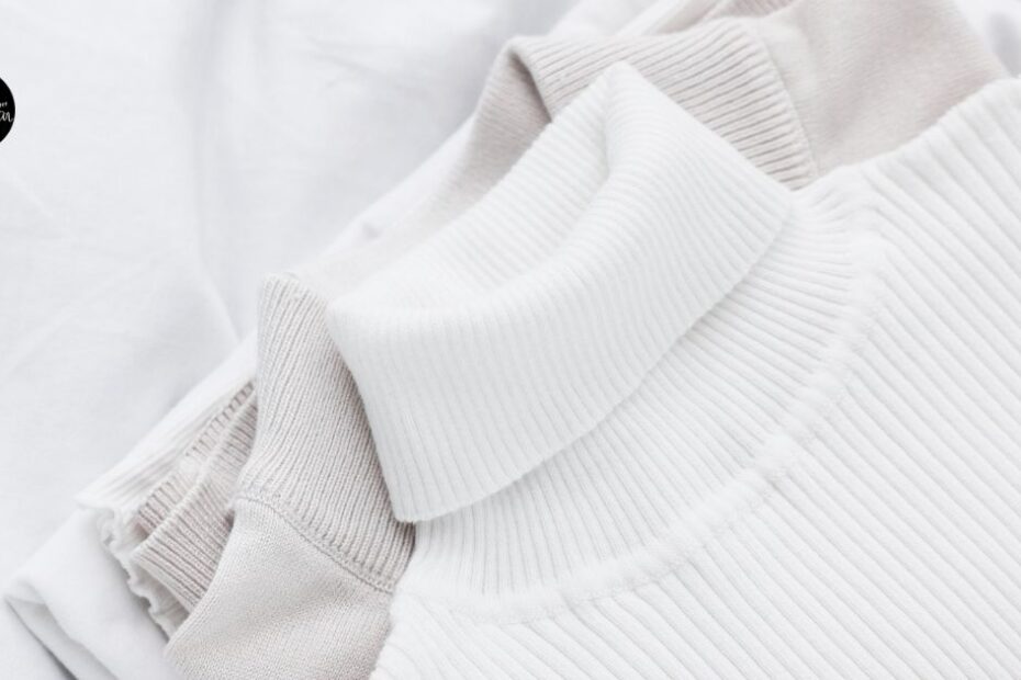 White clothes folded on fabric background