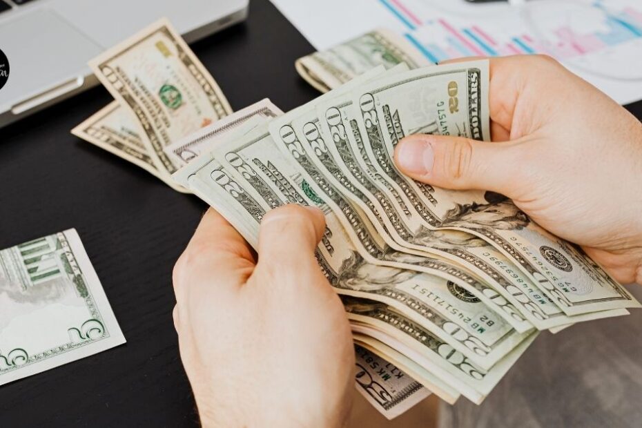 Hands counting cash on desk