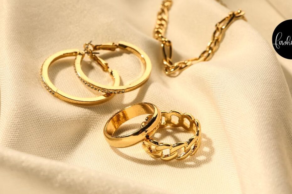 Gold jewelry on top of a cream-colored fabric