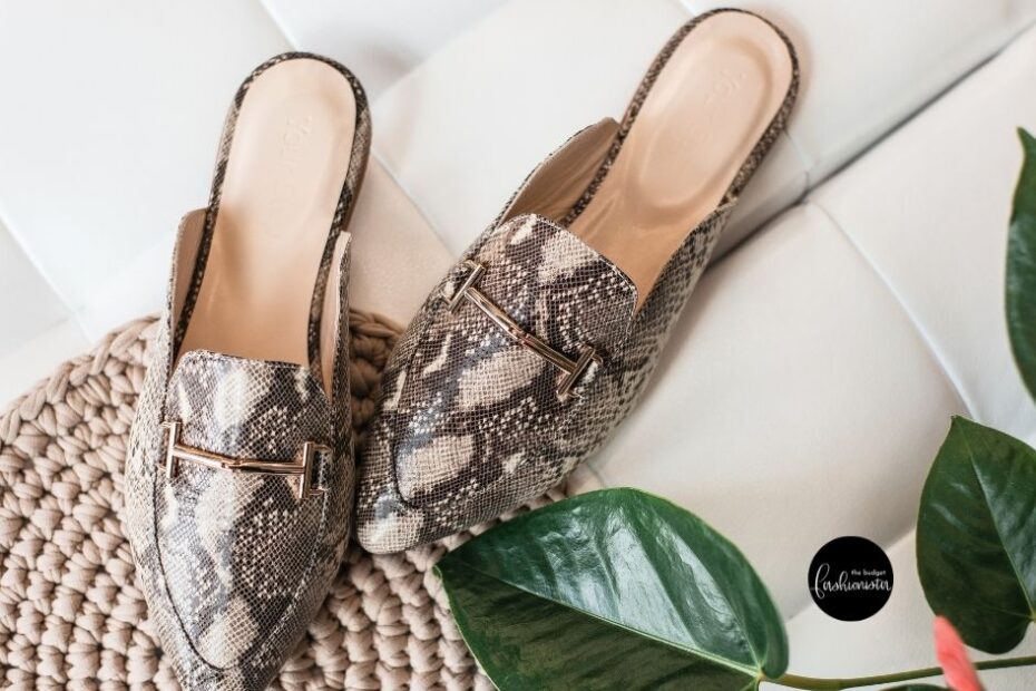Snake-print mules on woven rug