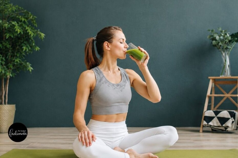 Woman drinking green smoothie after yoga