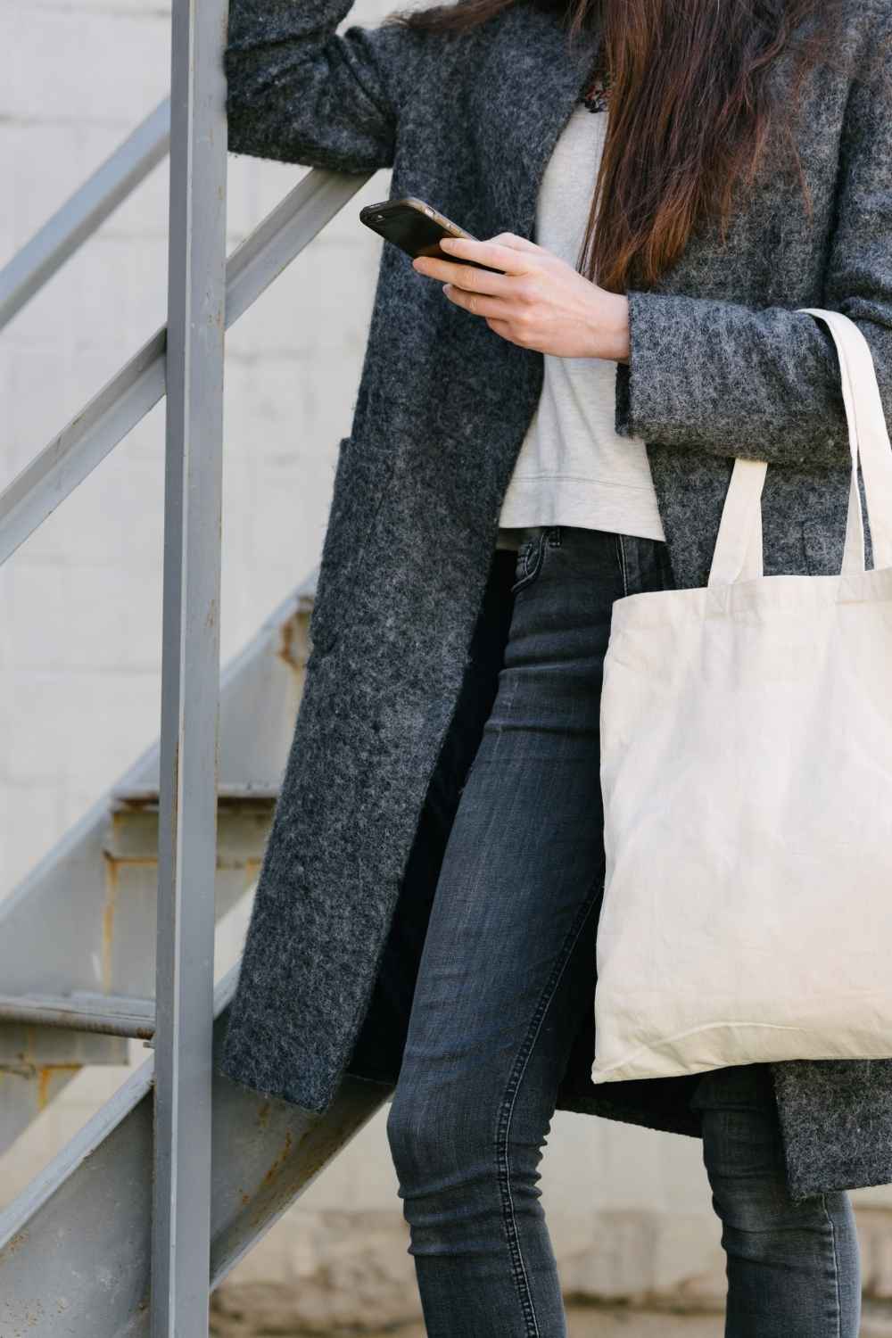 Bag rut? 7 handbags that work as hard as your go-to crossbody 1 Close up of stylish woman carrying canvas tote bag