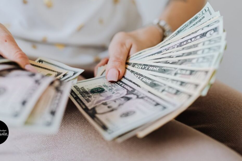 Close up of woman's hands holding dollar bills