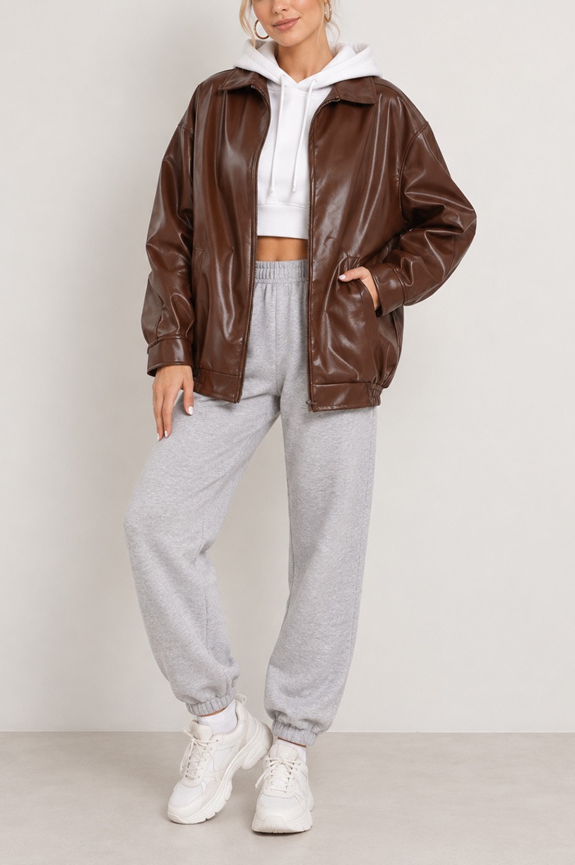Brown leather jacket, 9 ways: Outfit ideas for every style 3 Model wearing slouchy bomber faux leather jacket with joggers